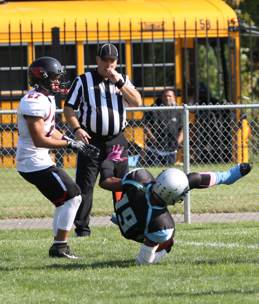 Nikos Frazier | The Vindicator..East's Leon Bell(19) flips into the end-zone for the two point conversion in the first quarter at Rayen Stadium in Youngstown on Saturday, Oct. 15, 2016 as the Canfield Cardinals take on the East Panthers...Also pictured Canfields Paul French(27)