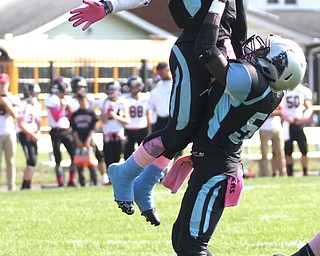 Nikos Frazier | The Vindicator..East's Leon Bell(19) jumps into the hands of Robert Allen(5) after a succesfull two point conversion in the first quarter at Rayen Stadium in Youngstown on Saturday, Oct. 15, 2016 as the Canfield Cardinals take on the East Panthers.