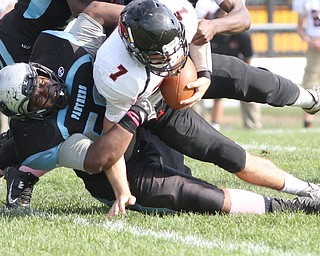 Nikos Frazier | The Vindicator..East's Chris Fitzgerald(56) takes down Canfield's quarterback,Chris Fitzgerald(56) after an attempted run in the second quarter at Rayen Stadium in Youngstown on Saturday, Oct. 15, 2016 as the Canfield Cardinals take on the East Panthers. (Nikos Frazier / KSU-JMC).