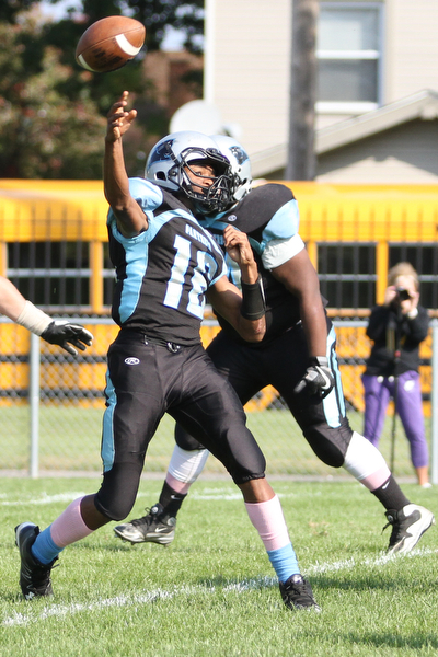 Nikos Frazier | The Vindicator..East's quarterback Thomas Steele(16) fires in the second quarter at Rayen Stadium in Youngstown on Saturday, Oct. 15, 2016 as the Canfield Cardinals take on the East Panthers.