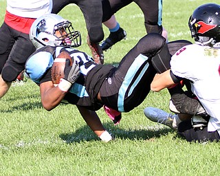 Nikos Frazier | The Vindicator..East's Marcus Finkley(25) is brought down by Canfield's Nick Ieraci(9) in the second quarter at Rayen Stadium in Youngstown on Saturday, Oct. 15, 2016 as the Canfield Cardinals take on the East Panthers.Nikos Frazier | The Vindicator..