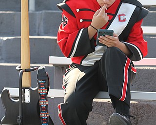 Nikos Frazier | The Vindicator..A member of the Canfield Band looks at her phone during the 3rd quarter while the Canfield Cardinals take on East High Panters at Rayen Stadium in Youngstown on Saturday, Oct. 15, 2016.(Nikos Frazier / KSU-JMC)