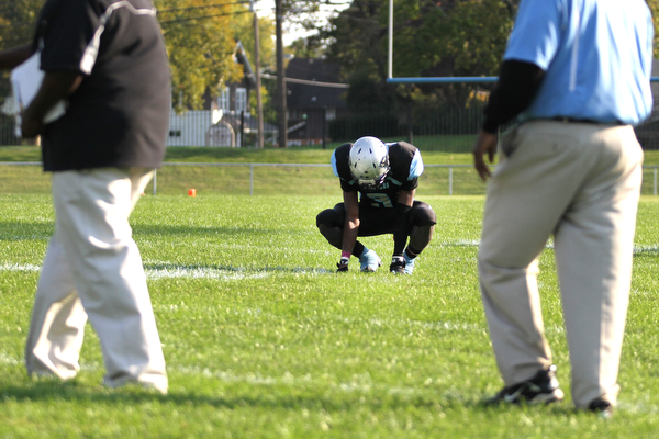 Nikos Frazier | The Vindicator..East's Michael Ramey(3) kneels in the center of the field after being defeated by the Canfield Cardinals 45-8 during his last home game as a senior at Rayen Stadium in Youngstown on Saturday, Oct. 15, 2016. (Nikos Frazier / KSU-JMC)