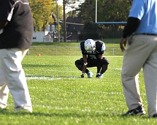 Nikos Frazier | The Vindicator..East's Michael Ramey(3) kneels in the center of the field after being defeated by the Canfield Cardinals 45-8 during his last home game as a senior at Rayen Stadium in Youngstown on Saturday, Oct. 15, 2016. (Nikos Frazier / KSU-JMC)