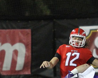 Nikos Frazier | The Vindicator..YSU's quarterback, Ricky Davis(12) is taken down in the first quarter as Youngstown State takes on Northern Illinois at Stambaugh Stadium in Youngstown on Saturday, Oct. 15, 2016.