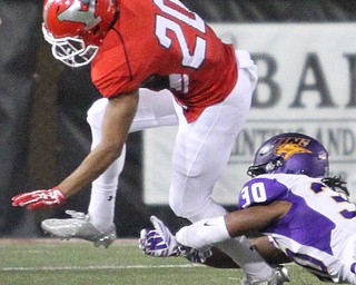 Nikos Frazier | The Vindicator..YSUs Jody Webb(20) attempts to escape the clutches of UNI's D'Shawn Dexter(30) in the first quarter as Youngstown State takes on Northern Illinois at Stambaugh Stadium in Youngstown on Saturday, Oct. 15, 2016.