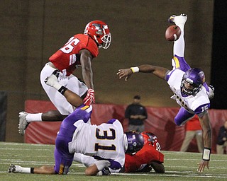 Nikos Frazier | The Vindicator..The ball is launched into the air in the second quarter as Youngstown State takes on Northern Illinois at Stambaugh Stadium in Youngstown on Saturday, Oct. 15, 2016. ..In the air: YSU Jameel Smith(26) and UNI Aaron Bailey(15).On the ground: UNI Michael Malloy(31) and YSU Jamar Pinnock(6)