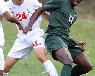 William D. Lewis The Vindicator  Money's Mark Armile(24) and Ursuline's Guy Kaho(11) go for the ball during 10-18-2016 action at Simon.