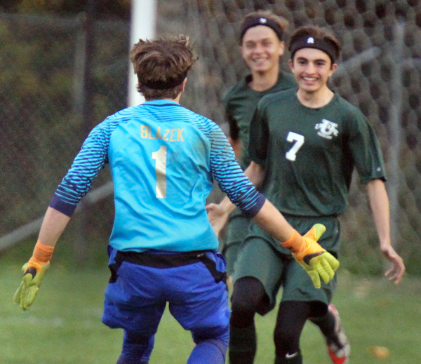 William D. Lewis The Vindicator Ursuline's Nick Beike(7) gets congrats from Bryce Blazek(1) after scoring the 2nd goal against Mooney 10-18-16.