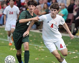 William D. Lewis The Vindicator Ursuline's Cody Rackoff(2) and Mooney's Patrik Brennan (4) go for the ball during 10-18-2016 action at Simon.