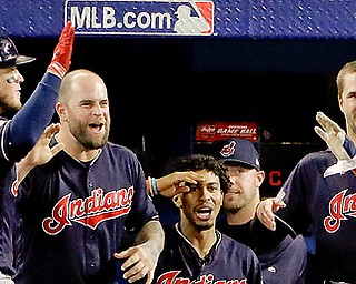 Cleveland Indians' Coco Crisp celebrates in the dugout after his home run against the Toronto Blue Jays during the fourth inning in Game 5 of baseball's American League Championship Series in Toronto, Wednesday, Oct. 19, 2016. (AP Photo/Charlie Riedel)