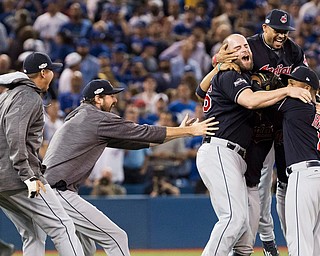 The Cleveland Indians celebrate after defeating the Toronto Blue Jays 3-0 during Game 5 of the baseball American League Championship Series, in Toronto on Wednesday, Oct. 19, 2016. (Mark Blinch/The Canadian Press via AP)