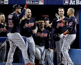 Cleveland Indians' Coco Crisp celebrates in the dugout after his home run against the Toronto Blue Jays during the fourth inning in Game 5 of baseball's American League Championship Series in Toronto, Wednesday, Oct. 19, 2016. (AP Photo/Charlie Riedel)