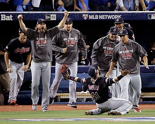 Cleveland Indians first baseman Carlos Santana celebrates after making the final out during the ninth inning in Game 5 of baseball's American League Championship Series against the Toronto Blue Jays in Toronto, Wednesday, Oct. 19, 2016. (AP Photo/Charlie Riedel)