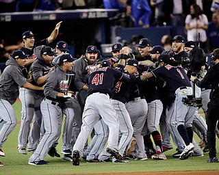 Members of the Cleveland Indians celebrate after their 3-0 win in Game 5 of baseball's American League Championship Series against the Toronto Blue Jays in Toronto, Wednesday, Oct. 19, 2016. (AP Photo/Charlie Riedel)