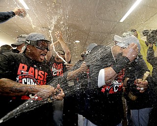 Members of the Cleveland Indians celebrates in the locker room after their 3-0 win against the Toronto Blue Jays in Game 5 of baseball's American League Championship Series in Toronto, Wednesday, Oct. 19, 2016. The Indians advance to the World Series. (AP Photo/Charlie Riedel)