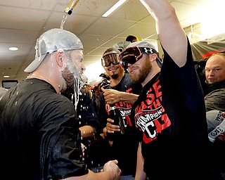 Cleveland Indians relief pitcher Cody Allen, right, celebrates with first baseman Mike Napoli celebrates in the locker room after their 3-0 win against the Toronto Blue Jays in Game 5 of baseball's American League Championship Series in Toronto, Wednesday, Oct. 19, 2016. The Indians advance to the World Series. (AP Photo/Charlie Riedel)