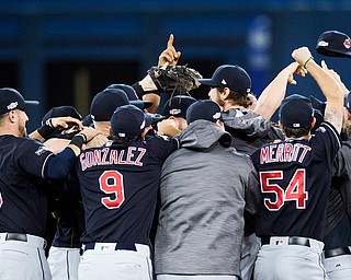 The Cleveland Indians celebrate after defeating the Toronto Blue Jays 3-0 during Game 5 of the baseball American League Championship Series, in Toronto on Wednesday, Oct. 19, 2016. (Frank Gunn/The Canadian Press via AP)