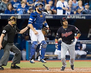 Home plate umpire Mike Everitt, left, Toronto Blue Jays catcher Russell Martin and Cleveland Indians' Coco Crisp watch Crisp's solo home run  during fourth inning in Game 5 of baseball's American League Championship Series in Toronto, Wednesday, Oct. 19, 2016. (Mark Blinch/The Canadian Press via AP)