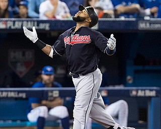 Cleveland Indians' Carlos Santana gestures skyward as he scores after hitting a home run against the Toronto Blue Jays during the third inning in Game 5 of baseball's American League Championship Series in Toronto, Wednesday, Oct. 19, 2016. (Mark Blinch/The Canadian Press via AP)
