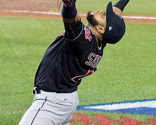 Cleveland Indians first baseman Carlos Santana celebrates after catching a foul pop-up for the final out against the Toronto Blue Jays during Game 5 of the baseball American League Championship Series, in Toronto on Wednesday, Oct. 19, 2016. (Frank Gunn/The Canadian Press via AP)