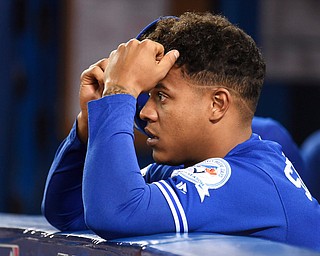 Toronto Blue Jays' Marcus Stroman watches from the dugout during the seventh inning in Game 5 of baseball's American League Championship Series against the Cleveland Indians in Toronto, Wednesday, Oct. 19, 2016. (Nathan Denette/The Canadian Press via AP)