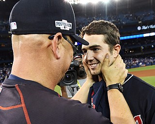 Cleveland Indians manager Terry Francona, left, congratulate starting pitcher Ryan Merritt after the Indians defeated the Toronto Blue Jays 3-0 during Game 5 of the baseball American League Championship Series, in Toronto on Wednesday, Oct. 19, 2016. (Frank Gunn/The Canadian Press via AP)