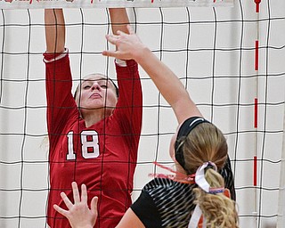 SALEM, OHIO - OCTOBER 19, 2016: Ellie Centofanti #10 of Springfield strikes the ball while Alexis Cross #18 of Columbiana goes for the block during their tournament game Wednesday night at Salem High School. Springfield won in three sets. DAVID DERMER | THE VINDICATOR