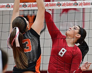 SALEM, OHIO - OCTOBER 19, 2016: Taylor Logan #8 of Columbiana strikes the ball while Lyndsey Smith #33 of Springfield goes for the block during their tournament game Wednesday night at Salem High School. Springfield won in three sets. DAVID DERMER | THE VINDICATOR