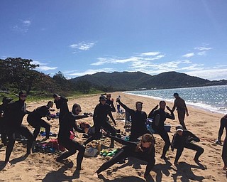 Neighbors | Submitted.Kibby and classmates are shown in their “ninja scientist” dive skins. They investigated methods to remove macroalgae (seaweed).  When coral rocks don’t have the macroalgae, coral larvae can adhere to the rocks better.