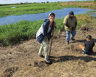 Neighbors | Submitted.Kibby is pictured planting native trees at Mungalla Station, with local Aboriginal families.