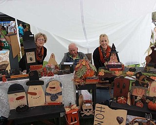 Neighbors | Abby Slanker.Cathy Karafa, Andrew Karafa and Kim Casey sold their wood crafts at the Junior Women’s League of Canfield’s Fall Market on Sept. 17. Andrew does all the woodwork, while Casey executes all the detail painting.