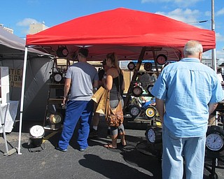 Neighbors | Alexis Bartolomucci.One of the vendors at the Youngstown flea market on Sept. 24 had his tent set up full of clocks that several of the guests checked out.