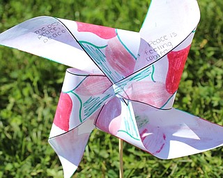 Neighbors | Abby Slanker.A Canfield High School freshman created, decorated and ‘planted’ a pinwheel with handwritten thoughts and feelings about peace for the international art and literacy project Pinwheels for Peace on Sept. 21.