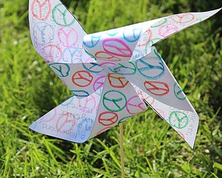 Neighbors | Abby Slanker.A Canfield High School freshman covered a pinwheel with peace signs for the international art and literacy project Pinwheels for Peace on Sept. 21.