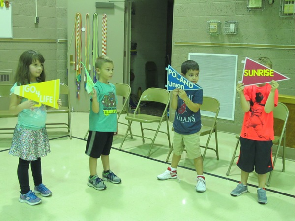 Neighbors | Alexis Bartolomucci.First-grade students at Poland Union held up signs to cheer on their classmates and the residents of Sunrise Assisted Living on Sept. 21 during the relay race.