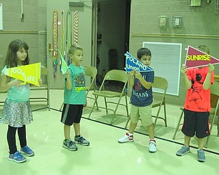 Neighbors | Alexis Bartolomucci.First-grade students at Poland Union held up signs to cheer on their classmates and the residents of Sunrise Assisted Living on Sept. 21 during the relay race.