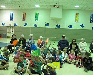 Neighbors | Alexis Bartolomucci.The first-grade students in Alice Colella's class sat with the residents of Sunrise Assisted Living as they waited for their cookies and milk on Sept. 21.