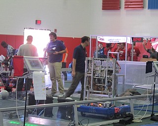 Neighbors | Alexis Bartolomucci.Robotics members and volunteers set up the robots on Sept. 25 during the FIRST Robotics Competition charity food drive at Austintown Middle School.