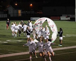 Neighbors | Abby Slanker.The 10 Canfield High School girls soccer team seniors led their team in running through a hoop banner prior to their game against Warren G. Harding during Senior Night on Oct. 5.