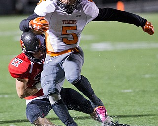 MICHAEL G TAYLOR | THE VINDICATOR- 10-21-16- 1st qtr, Howland's #5 Tyriq Ellis runs for a 1st down as   Canfield's #27 Paul French brings him down. Howland Tigers vs Canfield Cardinals at Bob Dove Field in Canfield, OH.