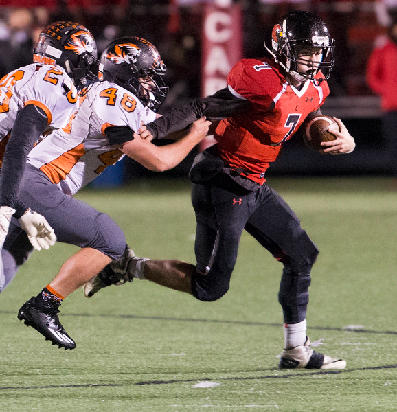 MICHAEL G TAYLOR | THE VINDICATOR- 10-21-16- 2nd qtr, Canfield's #7 Jake Cummings runs for a 1st down as Howland's #48 Phil Ginnis persues . Howland Tigers vs Canfield Cardinals at Bob Dove Field in Canfield, OH.