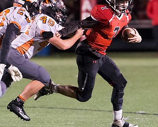 MICHAEL G TAYLOR | THE VINDICATOR- 10-21-16- 2nd qtr, Canfield's #7 Jake Cummings runs for a 1st down as Howland's #48 Phil Ginnis persues . Howland Tigers vs Canfield Cardinals at Bob Dove Field in Canfield, OH.