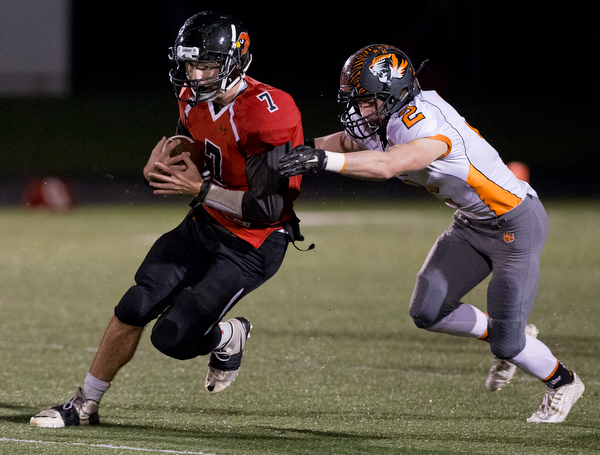 MICHAEL G TAYLOR | THE VINDICATOR- 10-21-16- 2nd qtr, Canfield's #7 Jake Cummings runs for a 1st down as Howland's #2 George Beatty-Marsh makes the tackle . Howland Tigers vs Canfield Cardinals at Bob Dove Field in Canfield, OH.
