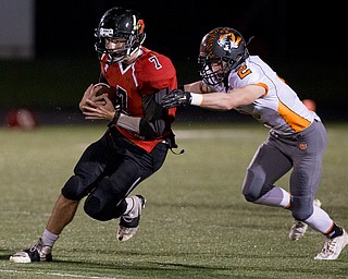 MICHAEL G TAYLOR | THE VINDICATOR- 10-21-16- 2nd qtr, Canfield's #7 Jake Cummings runs for a 1st down as Howland's #2 George Beatty-Marsh makes the tackle . Howland Tigers vs Canfield Cardinals at Bob Dove Field in Canfield, OH.