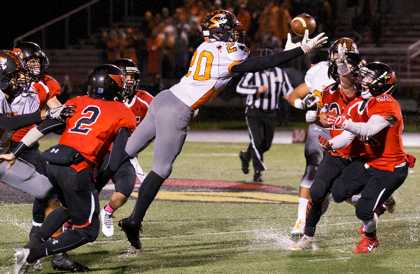 MICHAEL G TAYLOR | THE VINDICATOR- 10-21-16- 1st qtr, Howland's #20 recoveries his fumble on the game's initial kickoff. Howland Tigers vs Canfield Cardinals at Bob Dove Field in Canfield, OH.