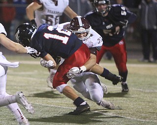 Boardman's Alex King (33) tackles Austintown Fitch quarterback Joey Zielinski (12) during the second quarter of Friday nights matchup at Fitch High School.   Dustin Livesay  |  The Vindicator  10/21/16  Austintown.