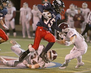 Austintown's Marquis Barbel (35) runs through Boardman's Mike Melewski (25) during the third quarter of Friday nights matchup at Fitch High School.   Dustin Livesay  |  The Vindicator  10/21/16  Austintown.