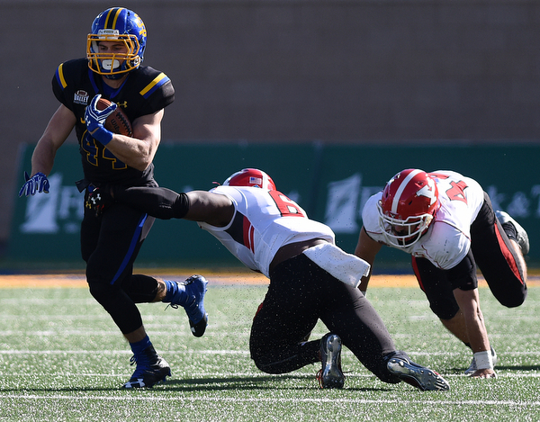 SDSU's Pete Menage carries the ball away from Youngstown defenders Jamar Pinnock (6) and Armand Dellovade (42) during their game at Dana J. Dykhouse Stadium on Saturday