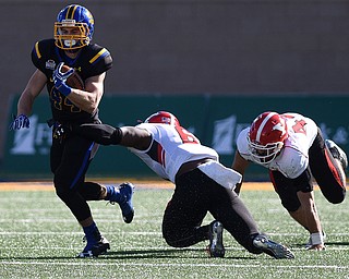 SDSU's Pete Menage carries the ball away from Youngstown defenders Jamar Pinnock (6) and Armand Dellovade (42) during their game at Dana J. Dykhouse Stadium on Saturday